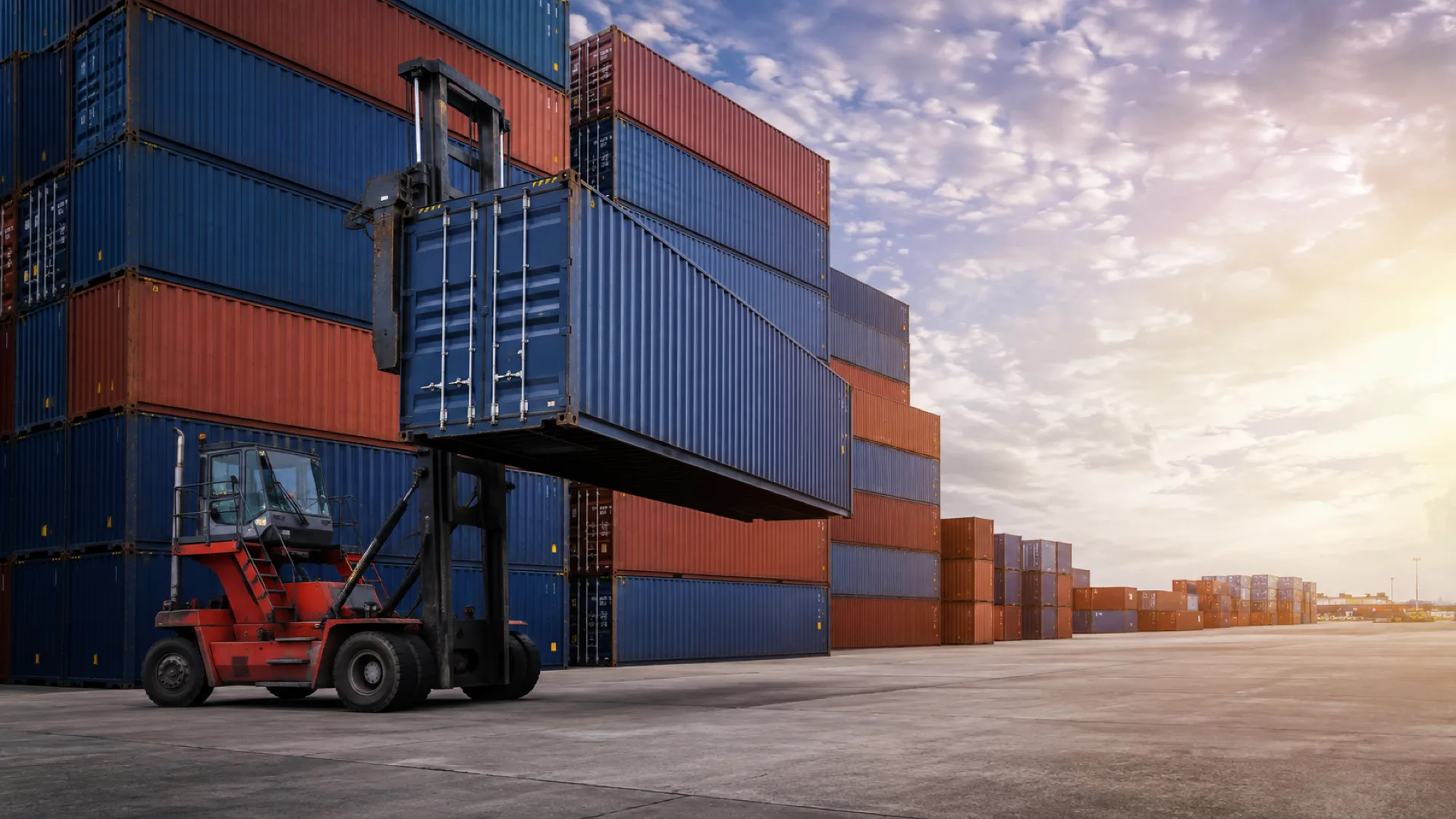 Forklift handling containers in a freight yard